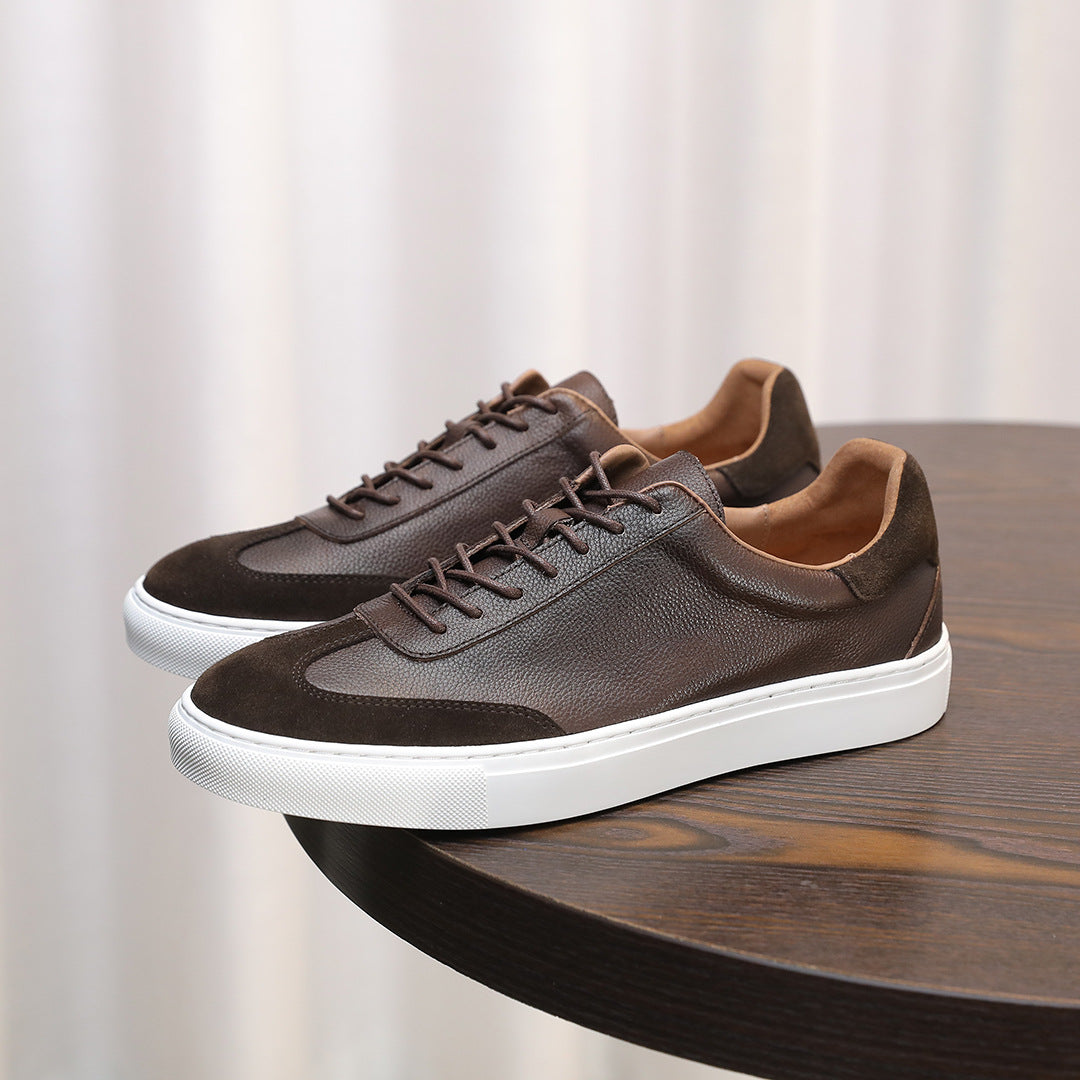 Men's leather sneakers in dark brown with lace-up front, suede panels, and white sole.