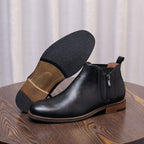 Men's black leather side-zip dress boots shown from side with pointed cap toe