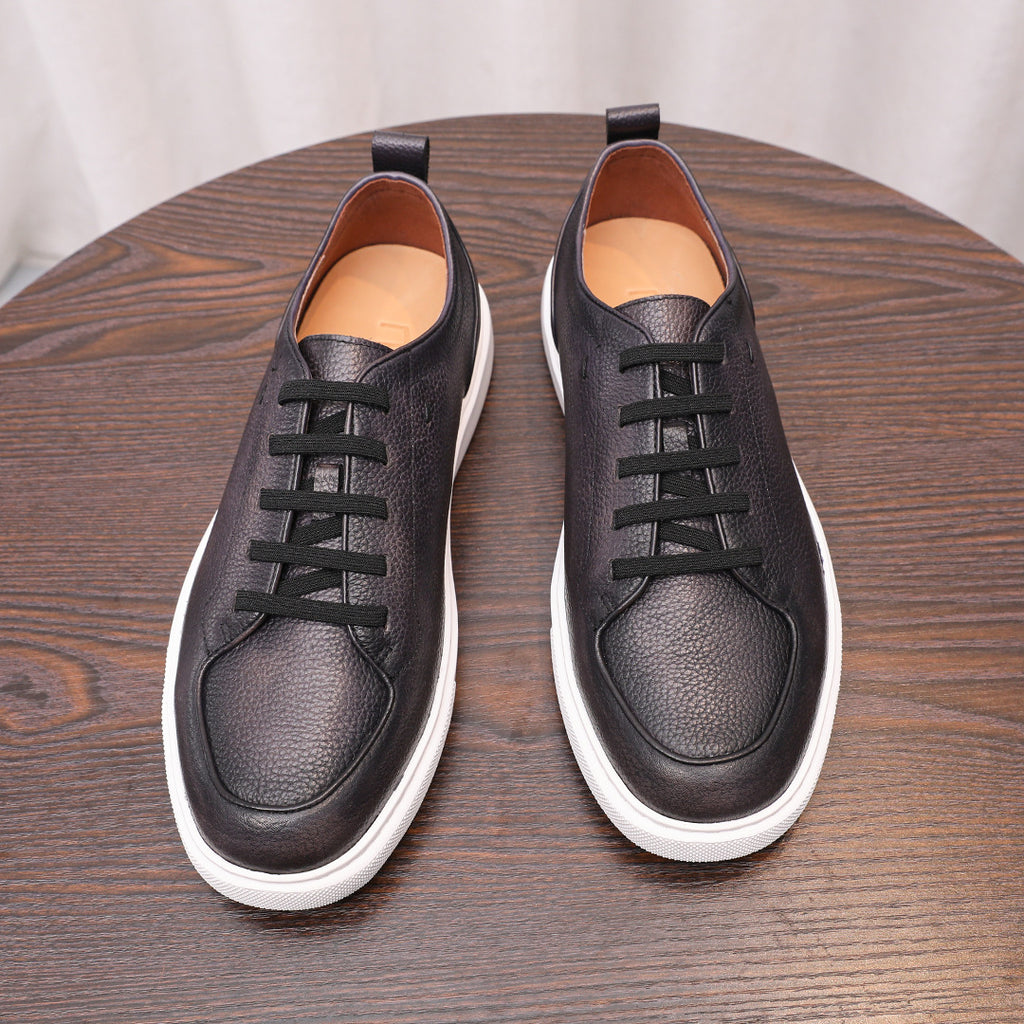 Black leather lace-up low-top sneakers with white rubber sole and dark padded collar