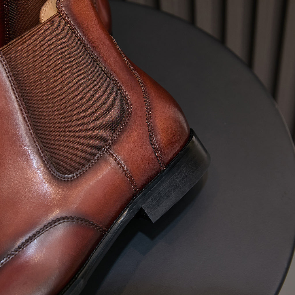 Men's pointed-toe Chelsea dress boot close-up of elastic gore and textured heel