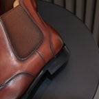Men's pointed-toe Chelsea dress boot close-up of elastic gore and textured heel