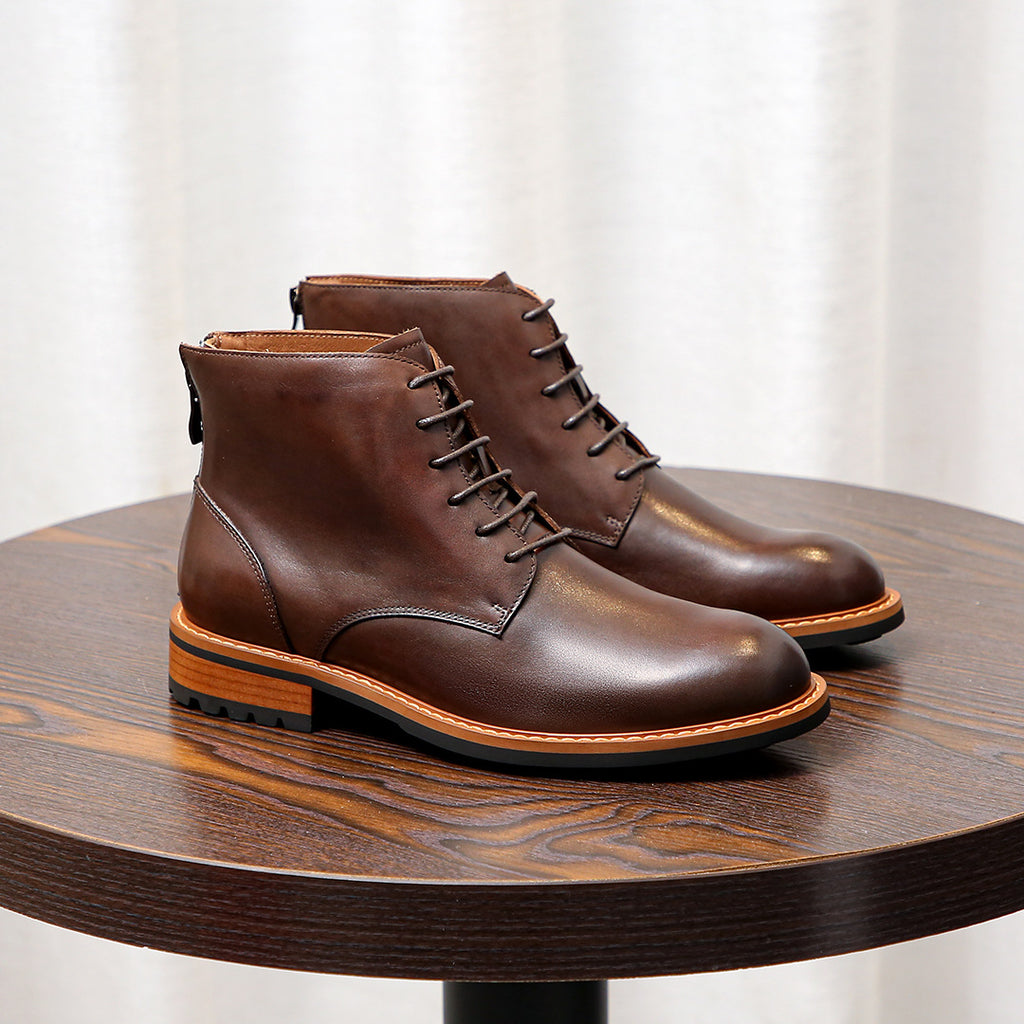 Dark brown leather pointed-cap toe ankle boots with lace-up front and orange welt