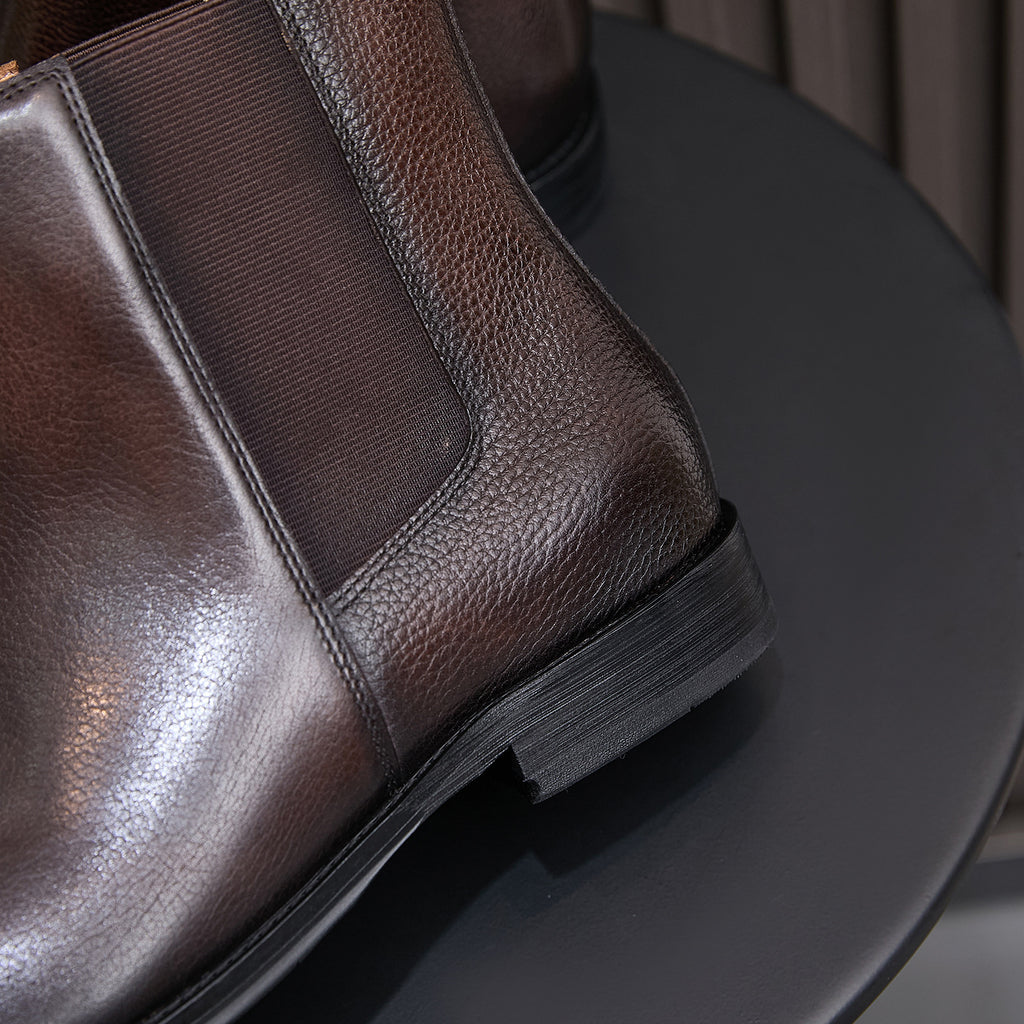 Dark brown suede Chelsea boot with pointed toe and elastic side panel