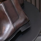 Dark brown suede Chelsea boot with pointed toe and elastic side panel