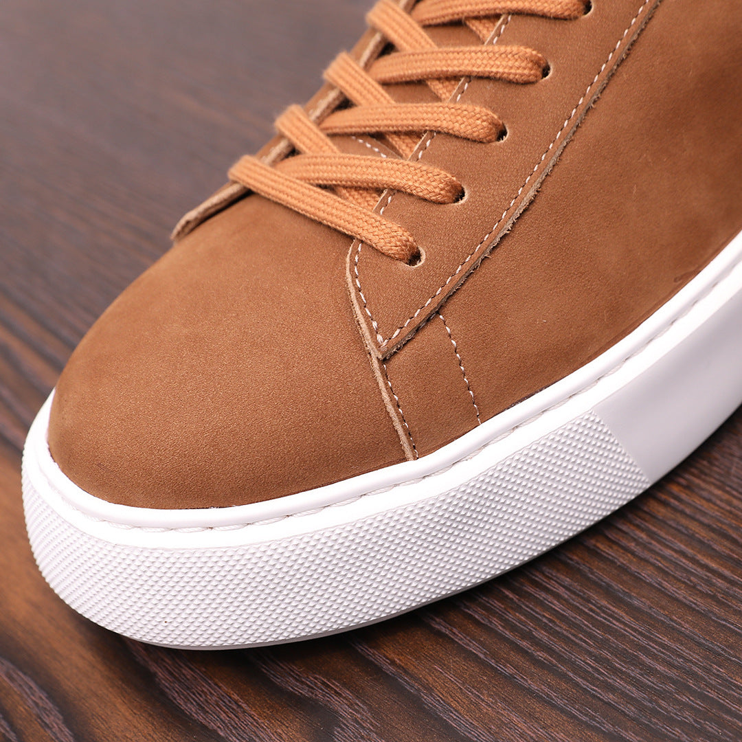 Close-up of men's brown suede leather sneaker with lace-up and white rubber sole