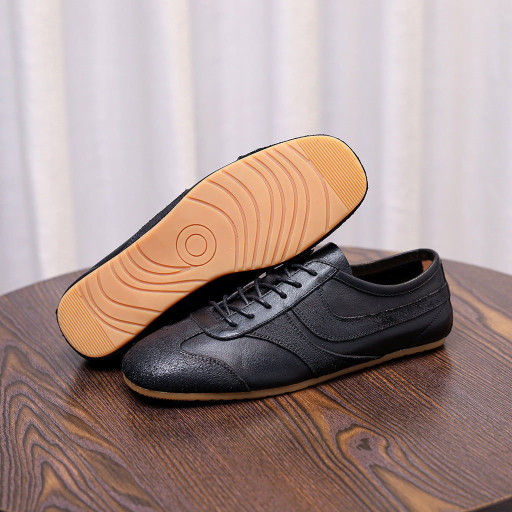 Men's black leather sneakers with lace-up front and visible tread outsole