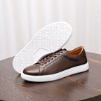 Dark brown leather sneakers with patterned white outsole