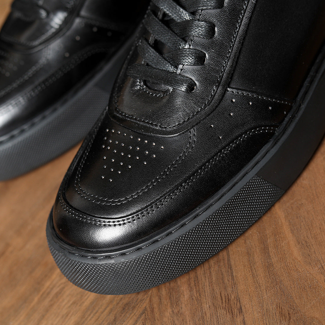 Black leather sneakers close-up, lace area, perforated toe and grippy rubber outsole