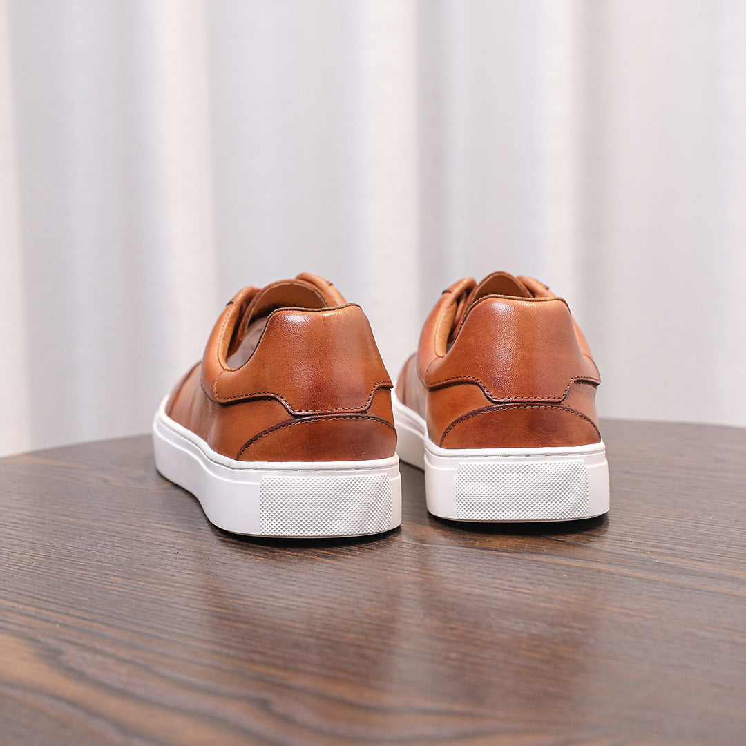 Brown genuine leather men's sneakers pair with back tabs and white rubber sole.