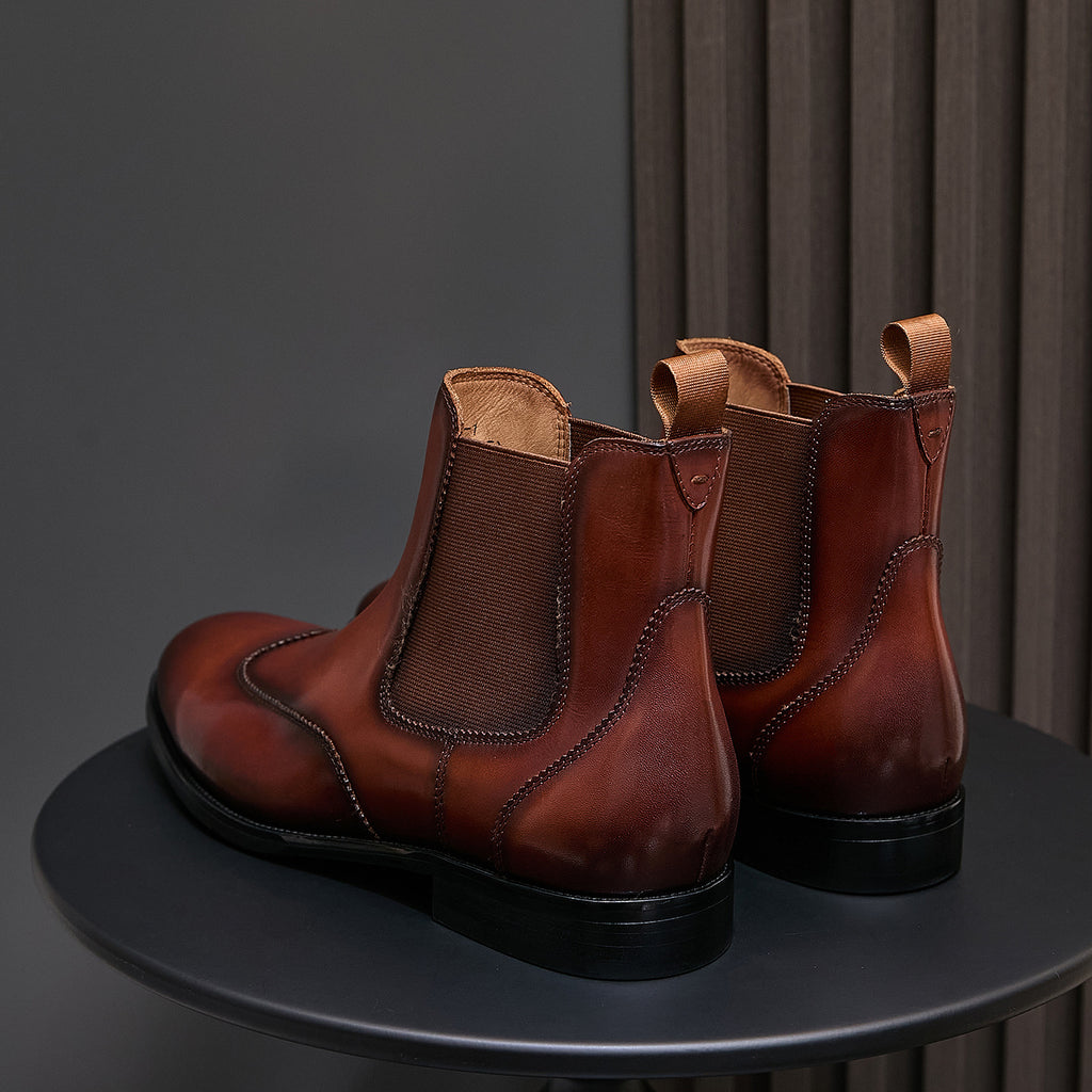 Men's pointed-toe Chelsea dress boots in dark brown, back view with pull tabs