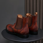 Men's pointed-toe Chelsea dress boots in dark brown, back view with pull tabs