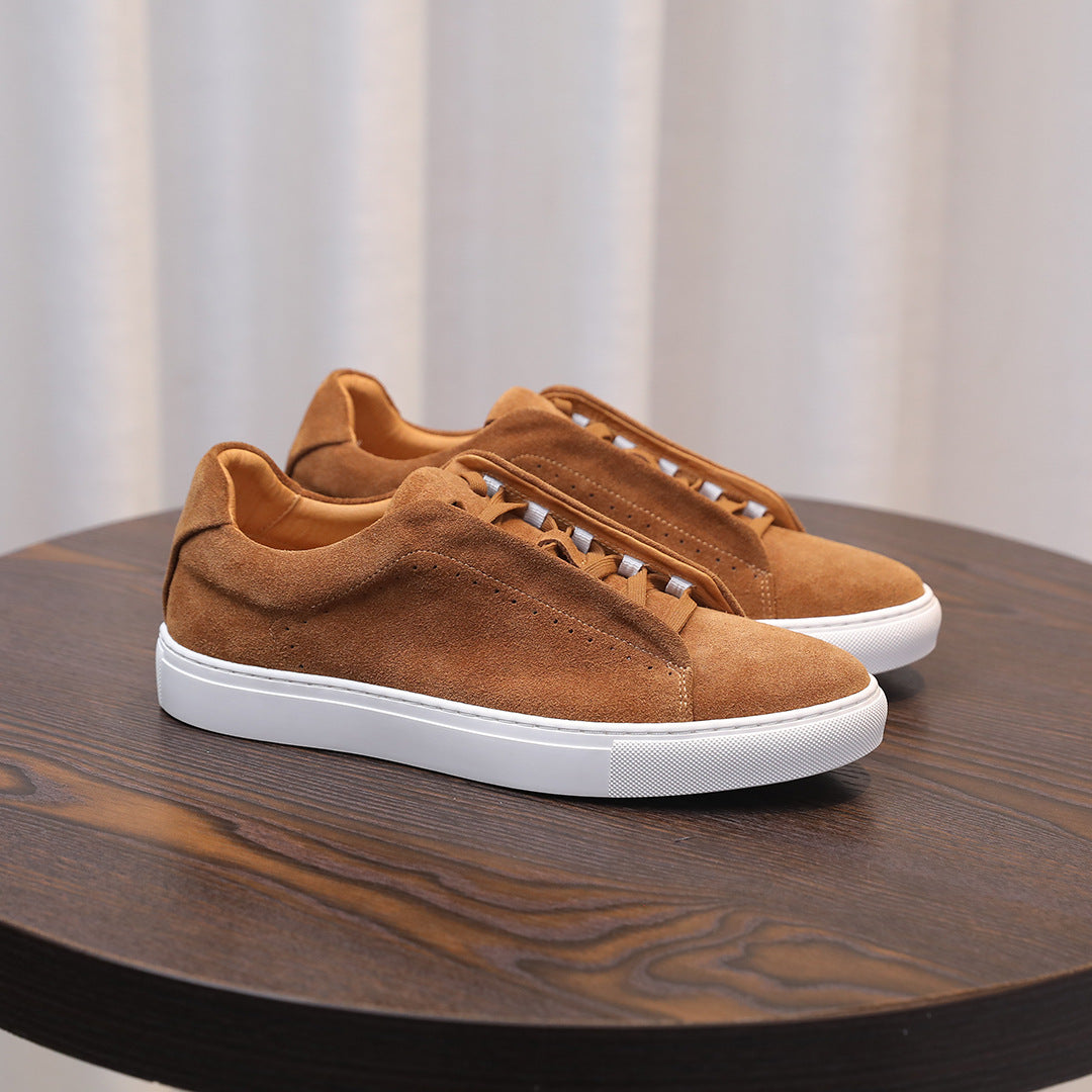 Men's brown suede sneakers with lace-up front and white sole, side angle