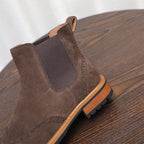 Brown suede Chelsea boot with elastic gore panels and lace-up style stitching