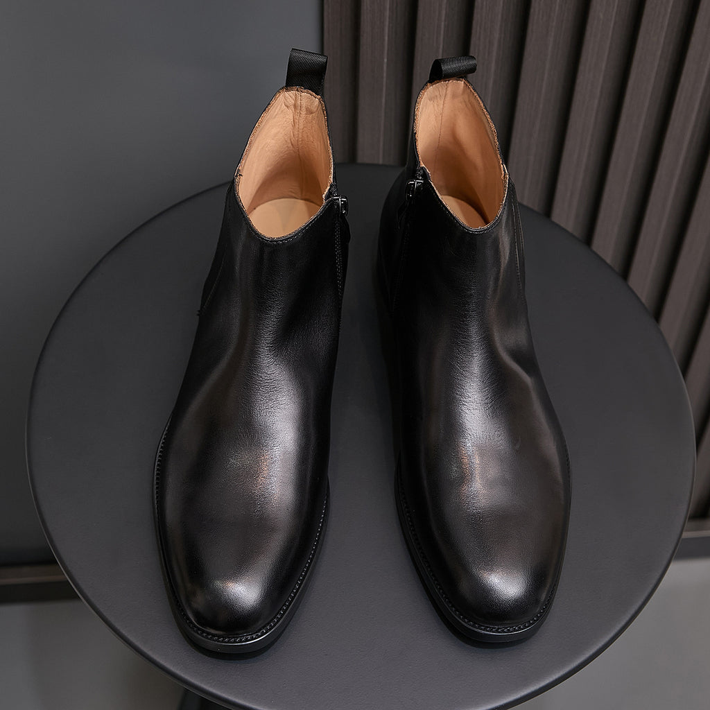 Black leather dress boots with pointed cap toe and side zip, front view pair
