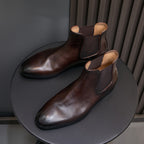 Dark brown suede Chelsea dress boots, side view with elastic gores and pointed toe