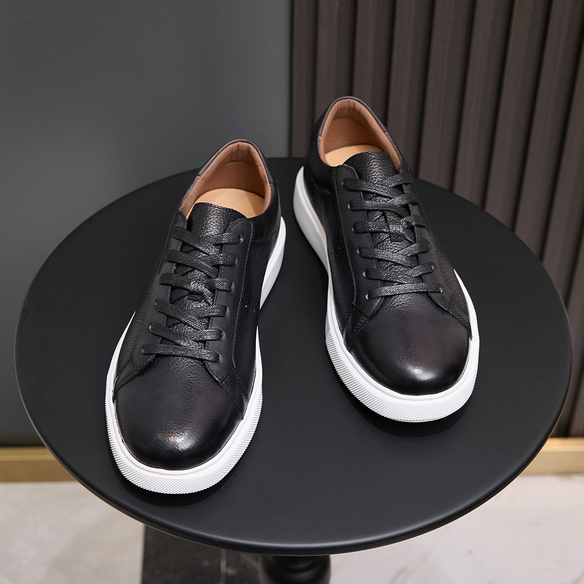 Men's black leather sneakers with lace-up front and white rubber sole