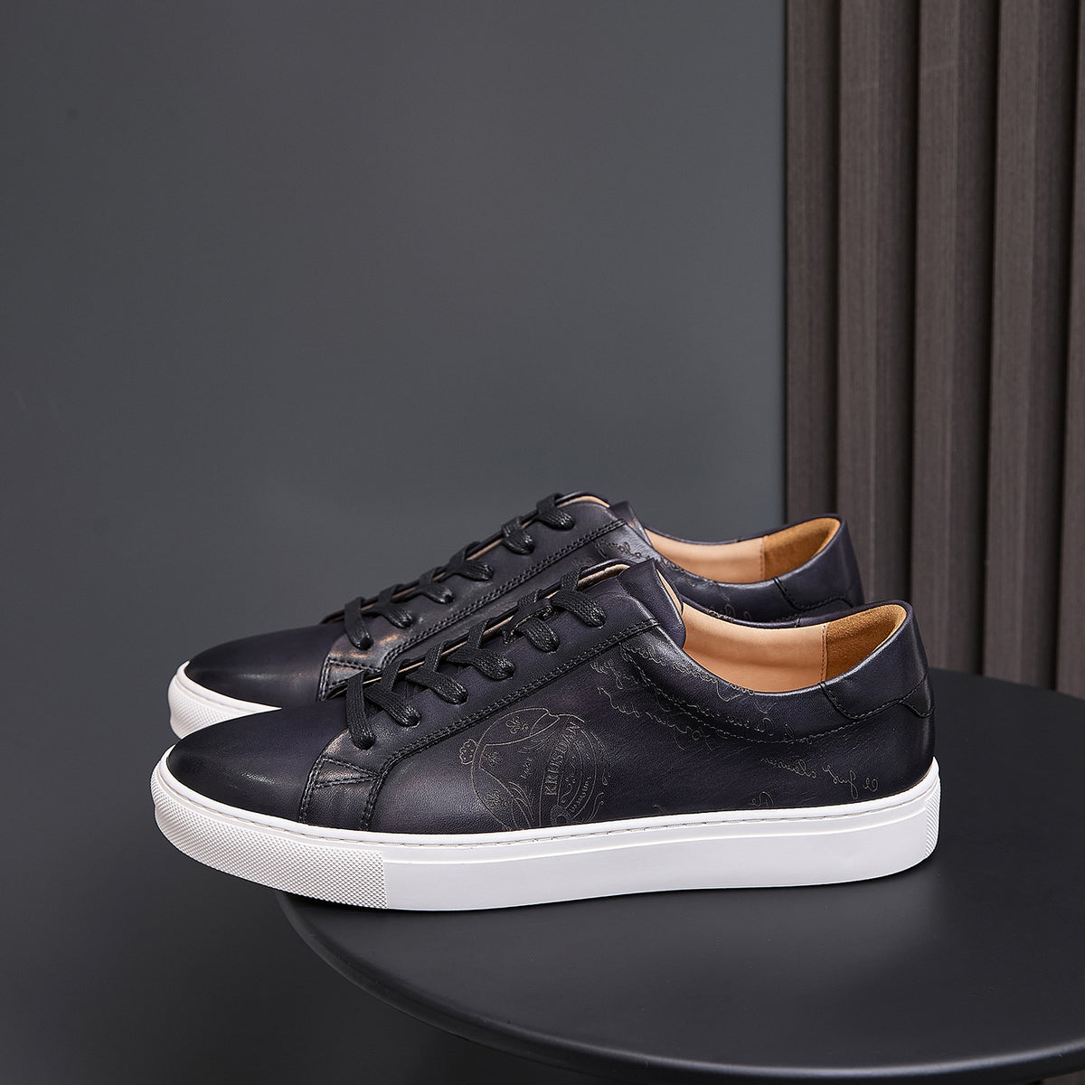 Men’s black leather lace-up sneakers with white rubber sole, low-top casual design