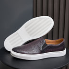 Men's dark leather slip-on sneakers with white rubber sole, minimalist style