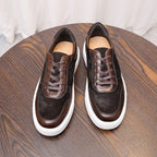 Brown leather sneakers pair, lace-up front view with white rubber sole