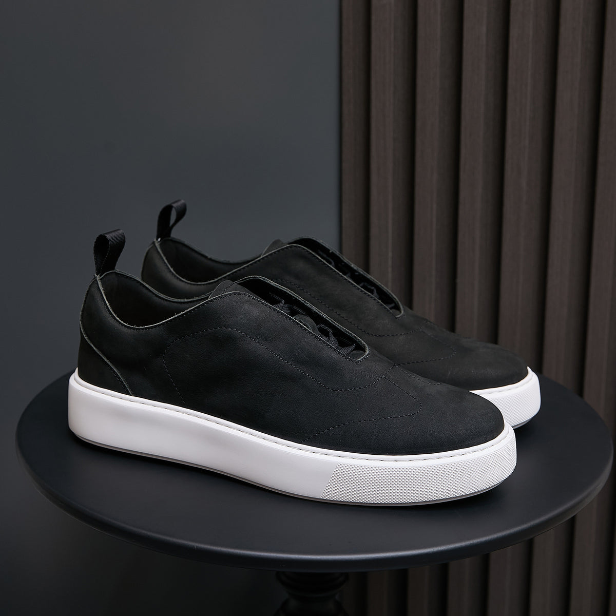Men's genuine leather sneakers in black, low profile with white rubber sole.