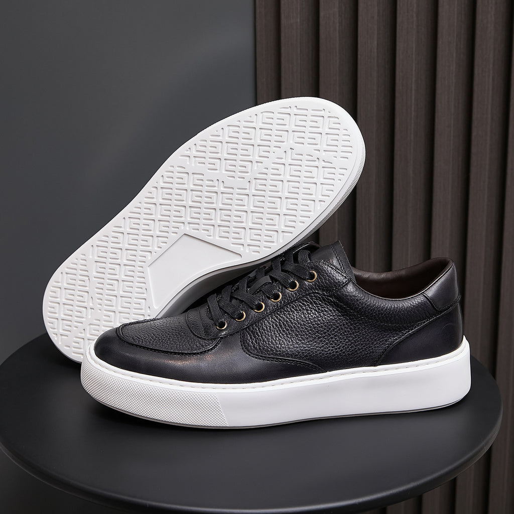 Black leather low-top sneakers with lace-up front and white rubber sole