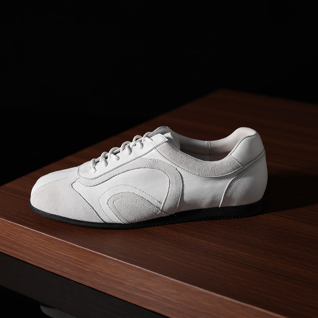 White leather low-top sneaker with lace-up closure and smooth quarter panel.