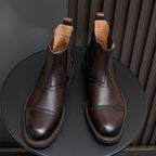 Men's pointed-toe Chelsea dress boots pair, dark brown leather look with elastic gore
