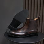 Men's pointed-toe Chelsea dress boot in dark brown, side view with wide block heel