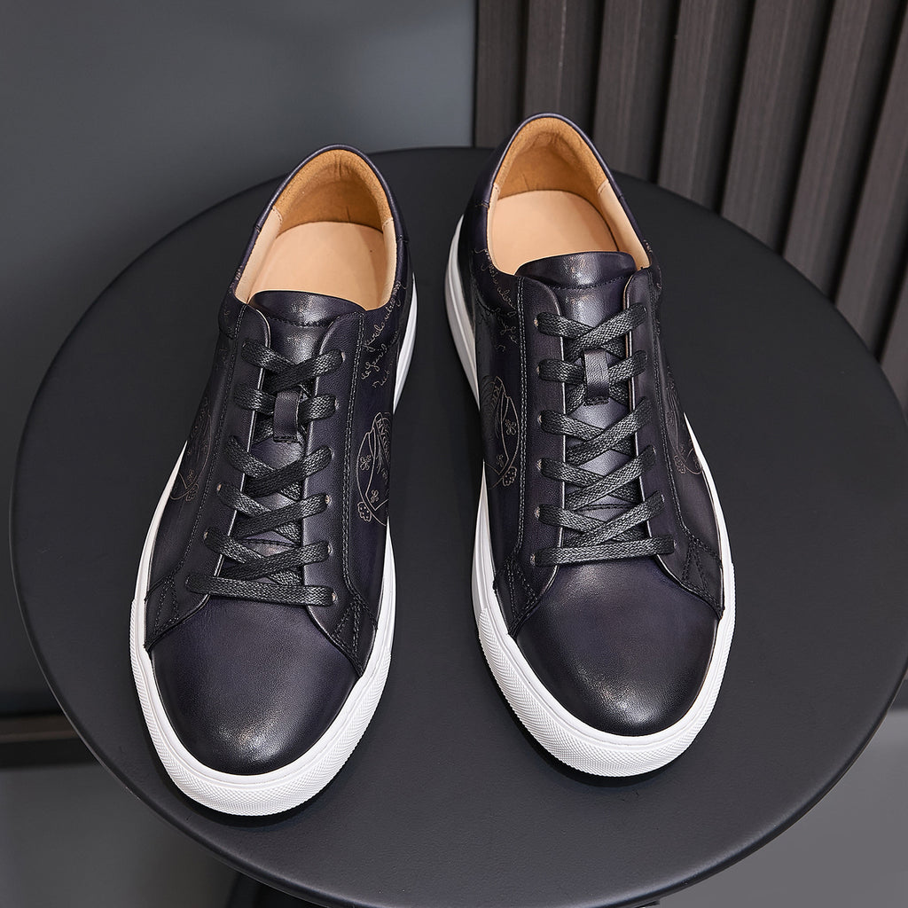 Pair of men’s black leather lace-up sneakers with white soles and tan interior lining