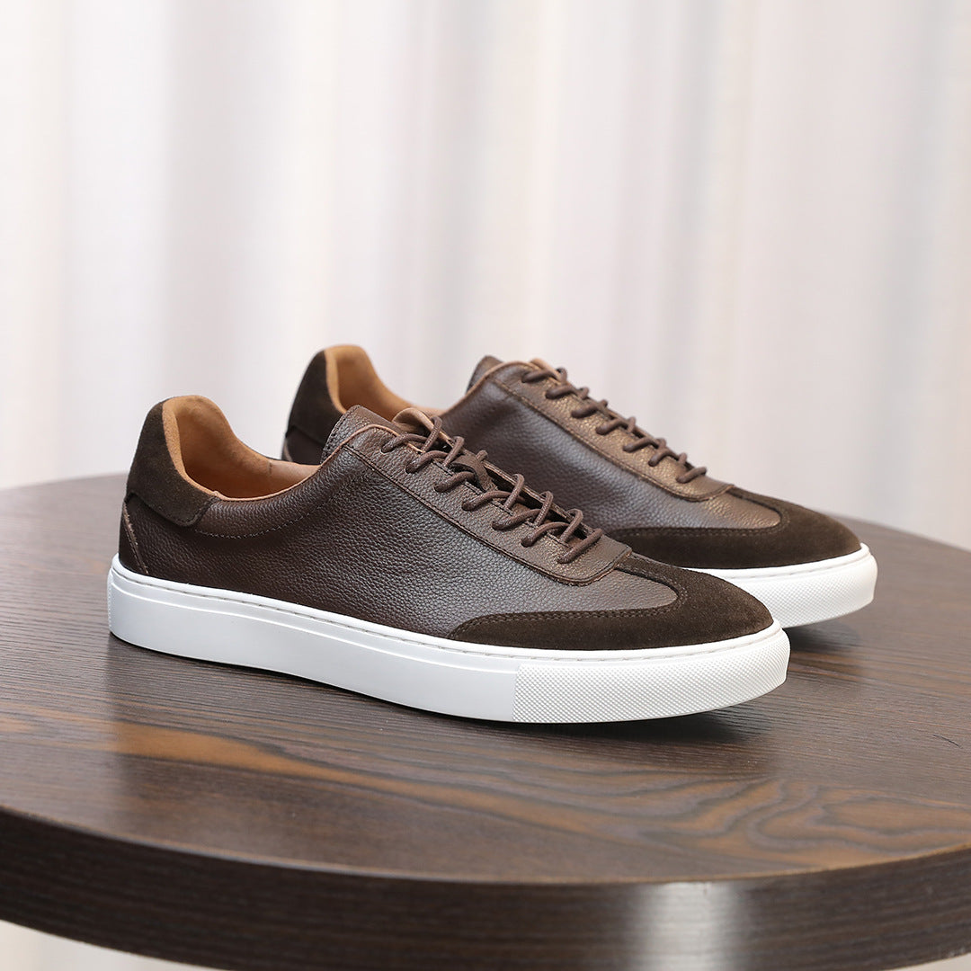 Men's dark brown leather sneakers with lace-up closure and white rubber sole.