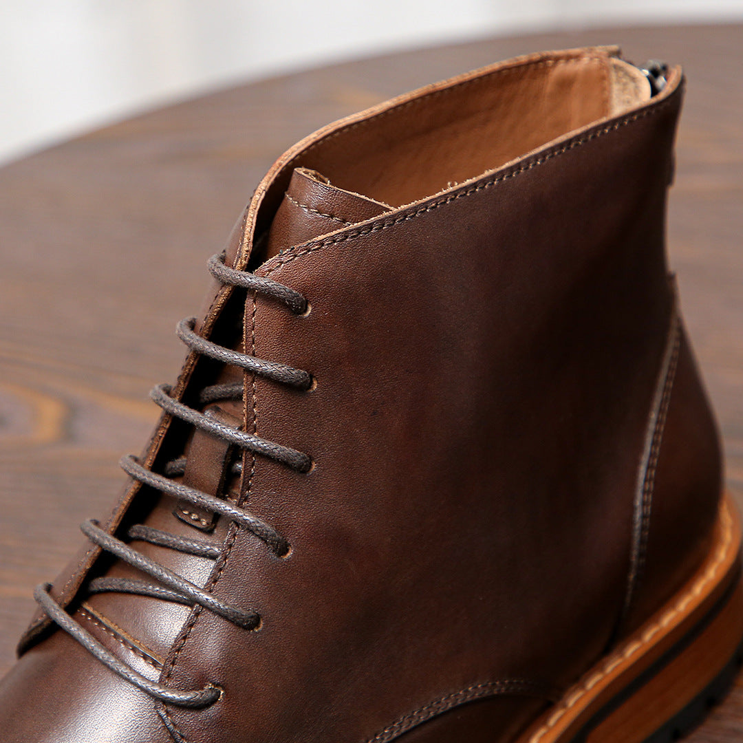 Dark brown leather lace-up ankle boot with stitched upper and orange trim