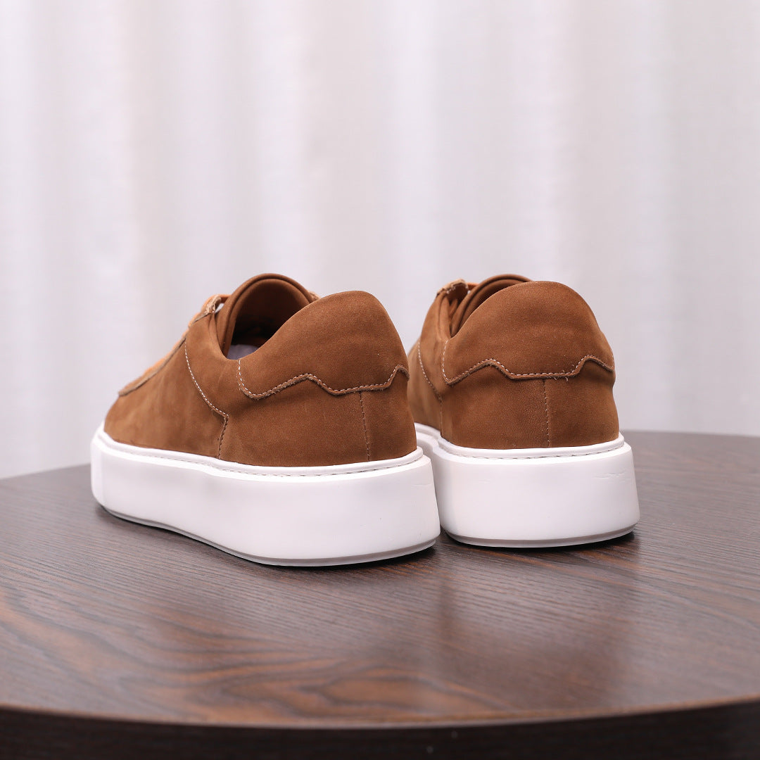 Brown leather sneakers with lace-up design and white rubber sole