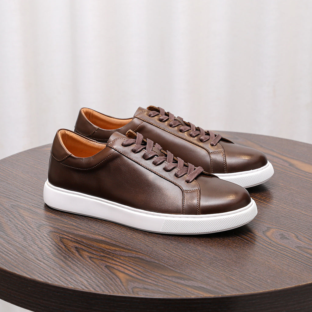 Men's dark brown leather sneakers with lace-up design and white rubber sole