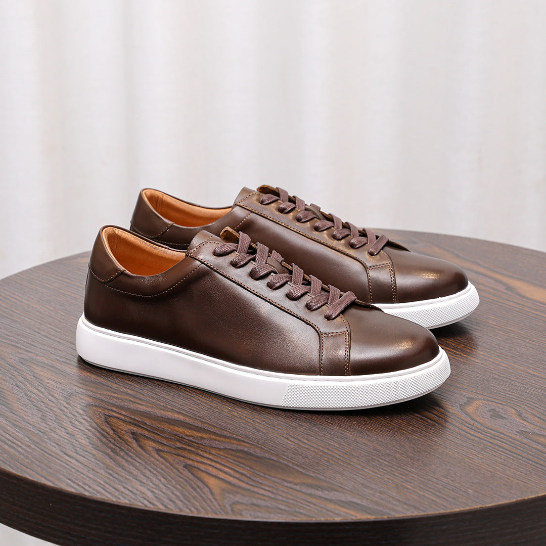 Men's dark brown leather sneakers with lace-up design and white rubber sole