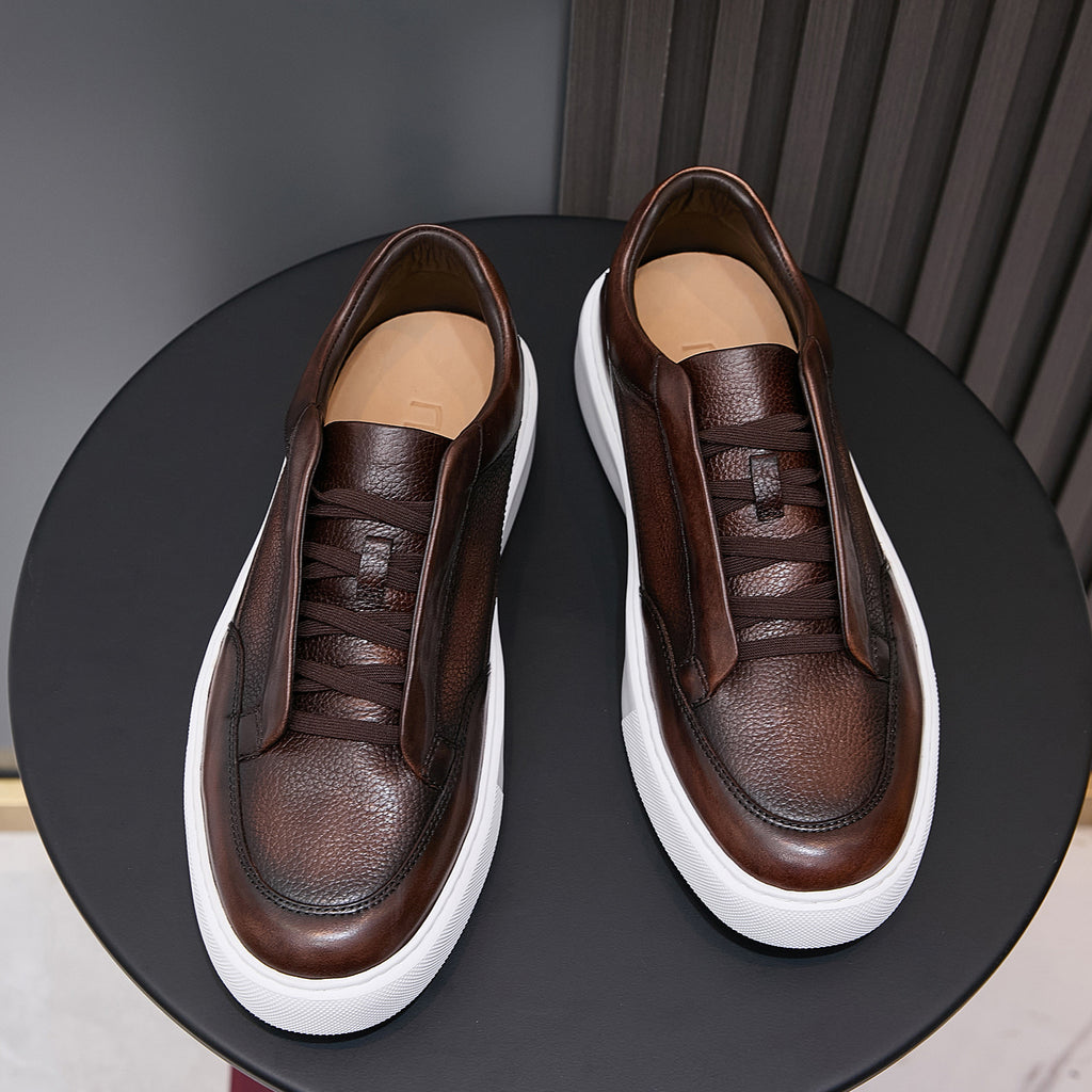 Men's genuine leather sneakers in dark brown, lace-up with white sole and tan lining.