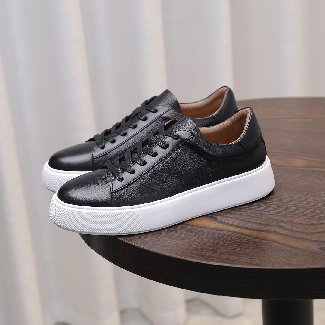 Black leather sneakers with lace-up closure and white platform-style sole.