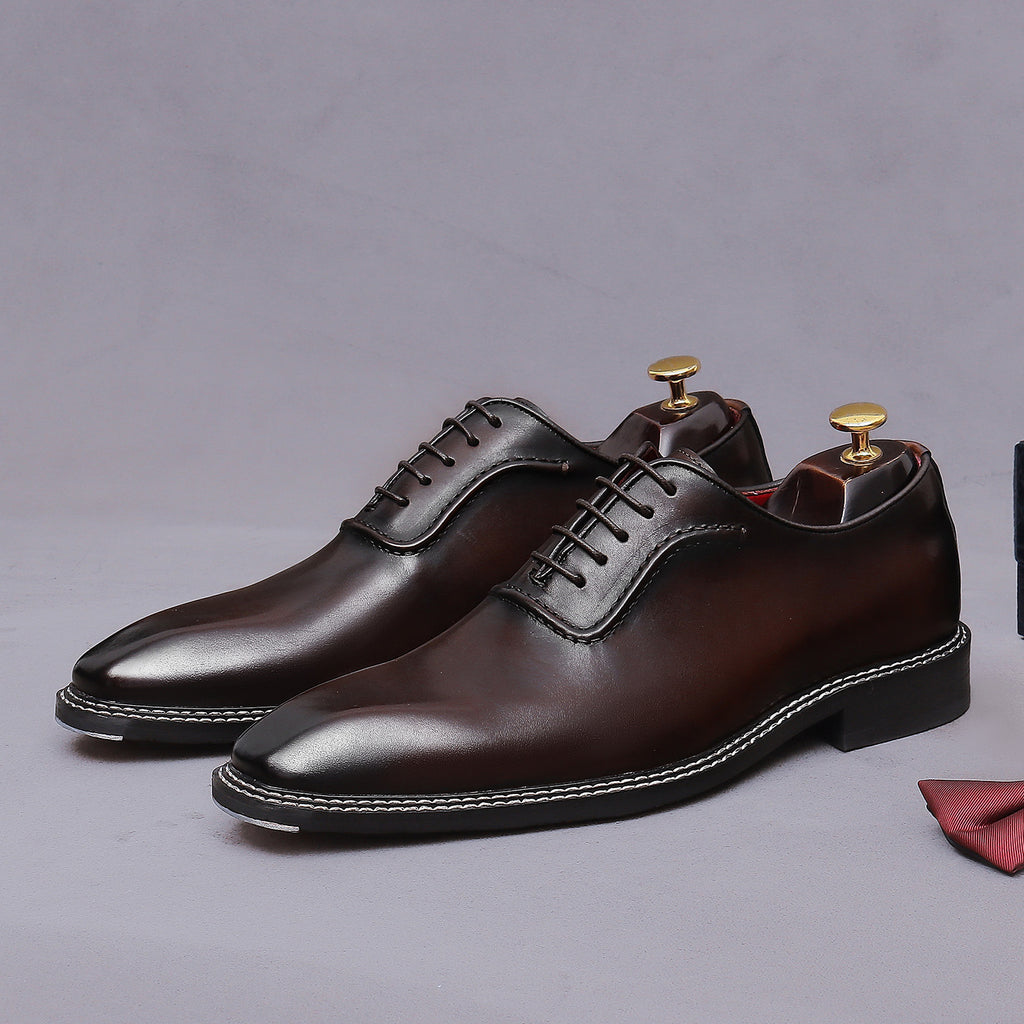 Men's chunky lug sole wingtip brogue oxford shoes in dark brown, side view with laces.