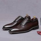 Men's chunky lug sole wingtip brogue oxford shoes in dark brown, side view with laces.