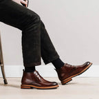 Men's brown leather chukka boots with plain toe and lace-up closure, chunky treaded sole