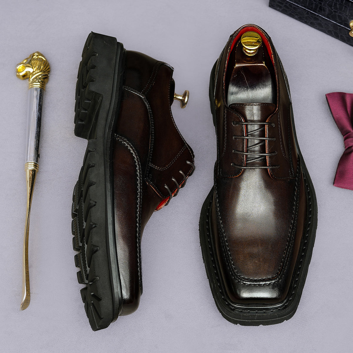 Men's chunky lug-sole wingtip brogue oxford shoes, dark color, side and front views.