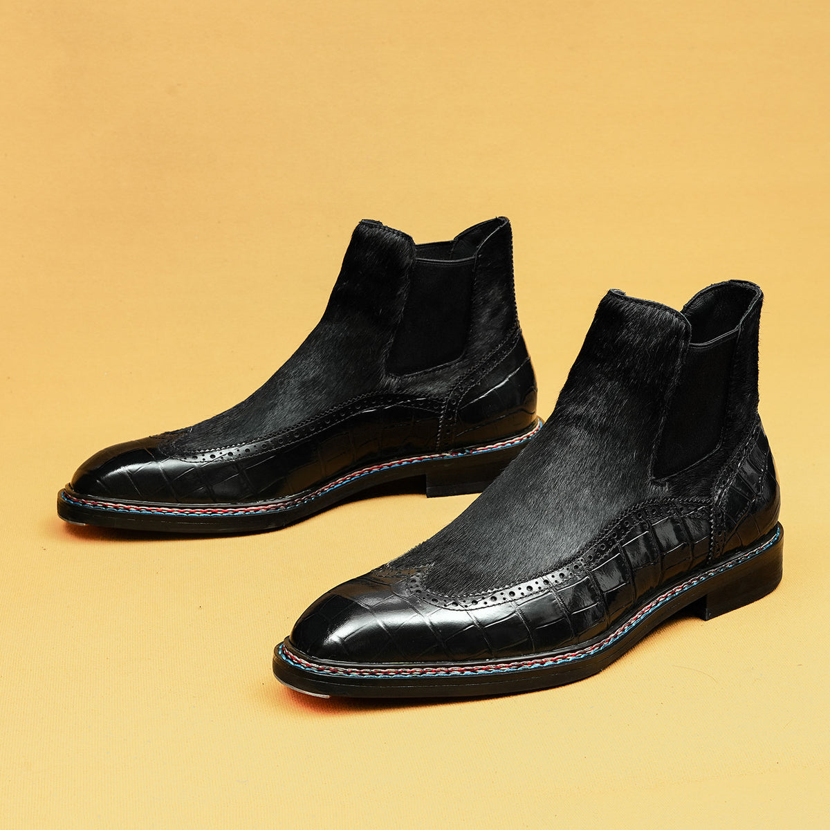 Black leather chelsea dress boots with elastic side panels and patterned toe detailing