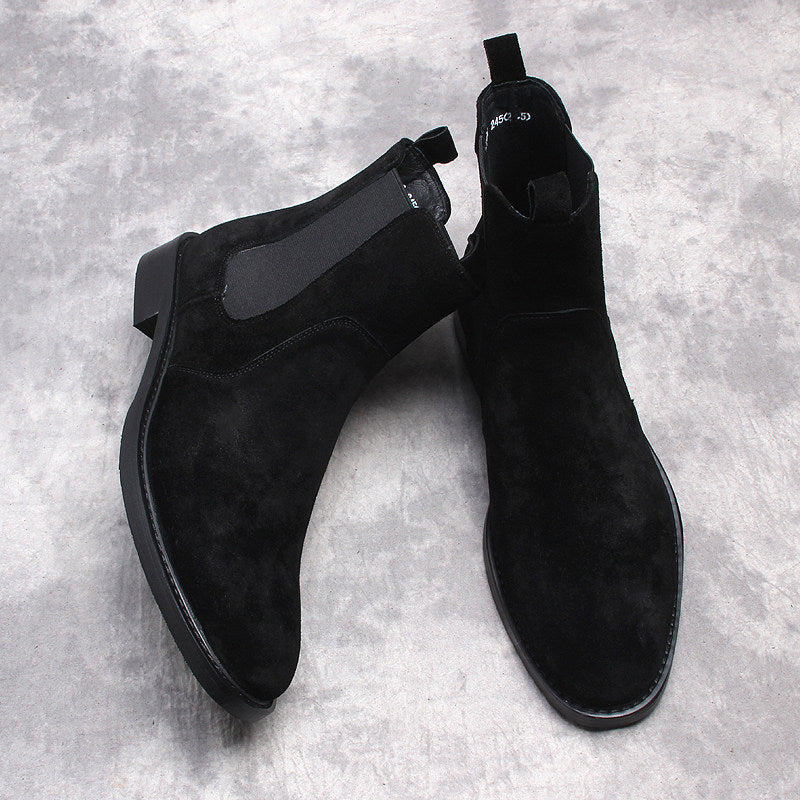 Black suede Chelsea dress boots pair, slip-on design with stitched upper panels