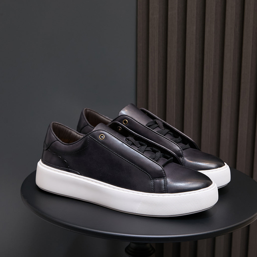 Men's black leather sneakers with lace-up closure and white sidewall sole