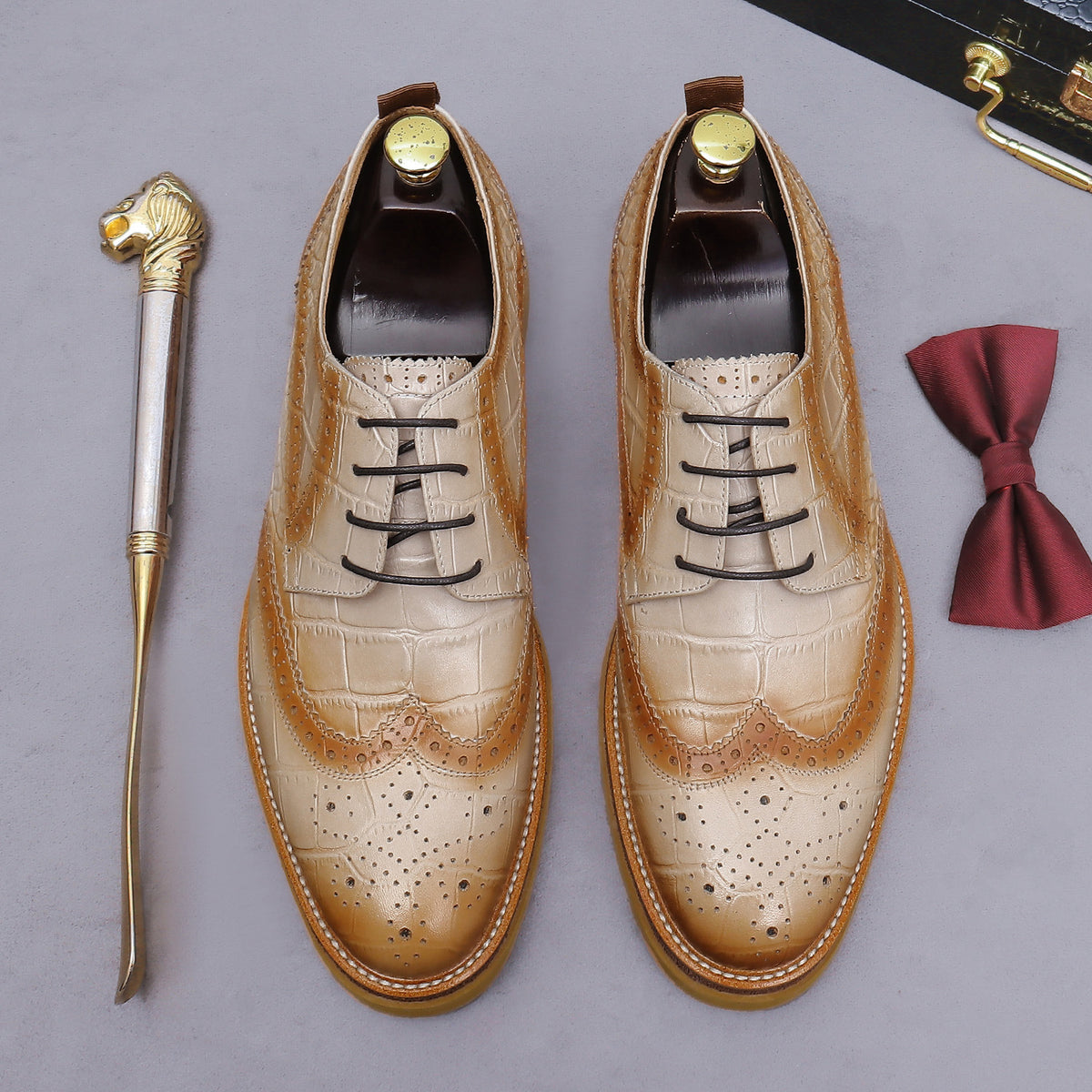 Men's tan pointed-toe leather derby shoes, lace-up with wingtip brogue details