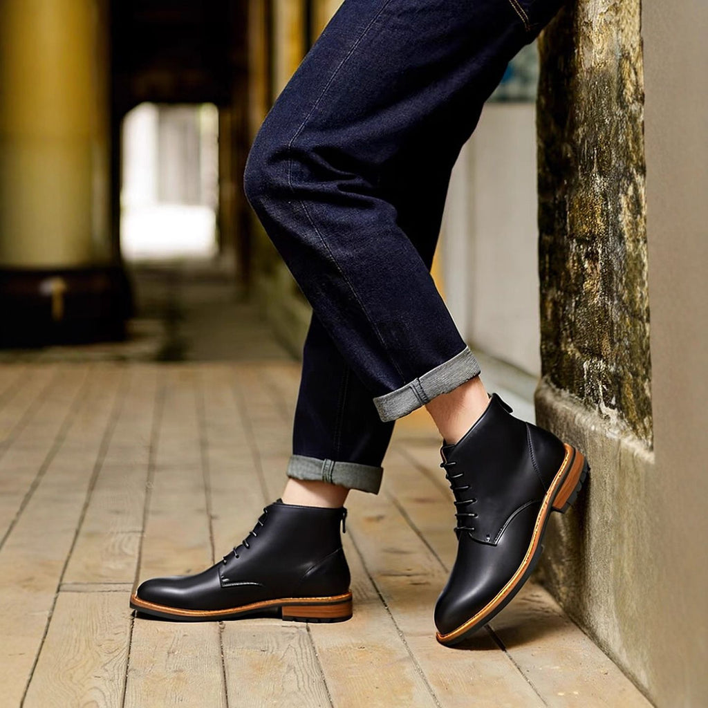 Black leather pointed-cap toe side-zip boots with laces and dark jeans