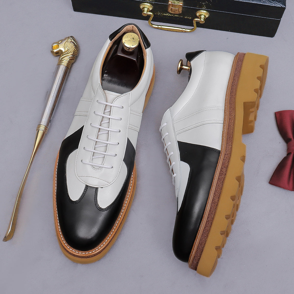 Men's white and black leather suede lace-up sneakers with tan gum lug sole