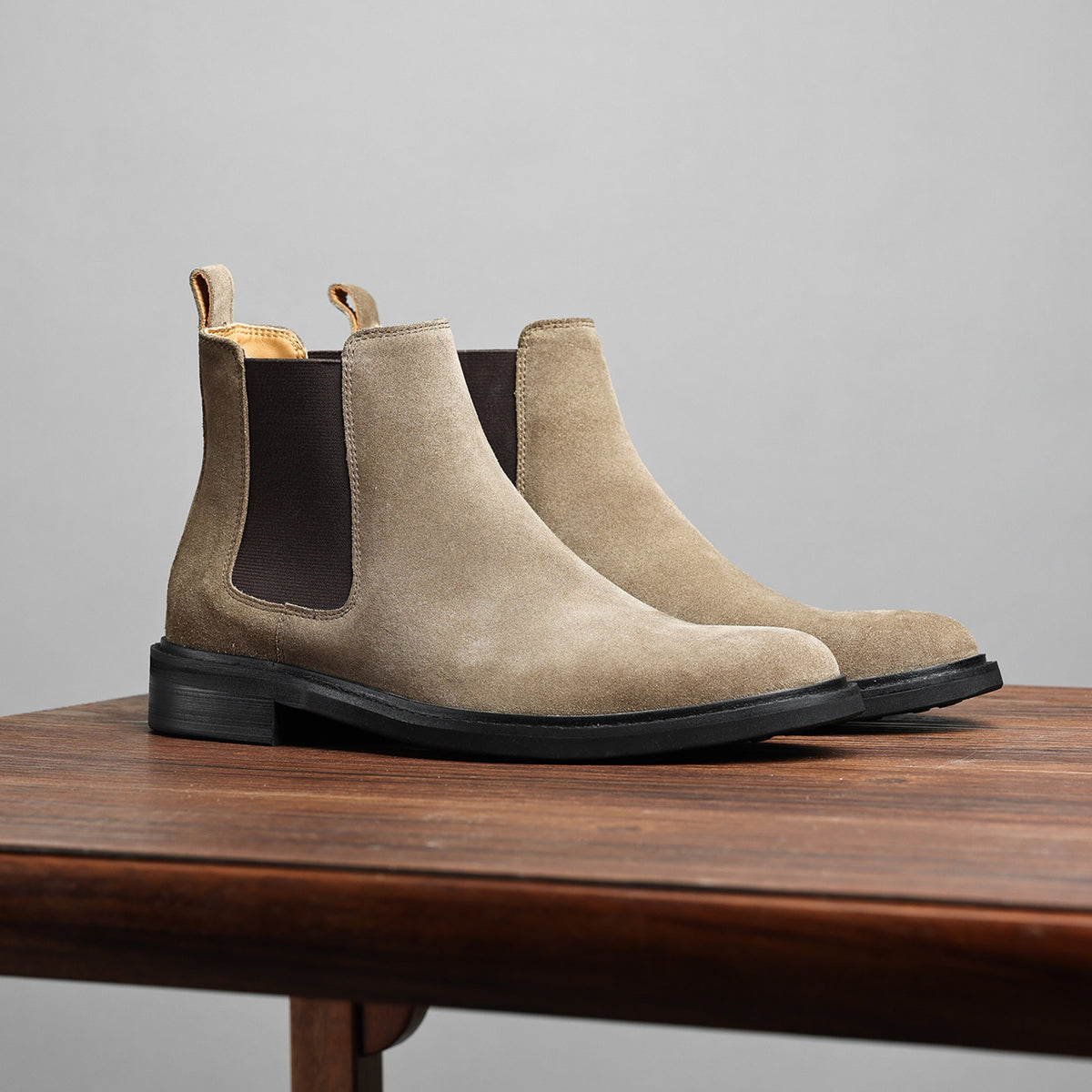 Taupe Chelsea dress boot side profile with elastic gore and low stacked heel.