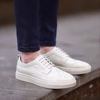 Men's genuine leather sneakers, white lace-up with V-shaped strap and perforated detailing.