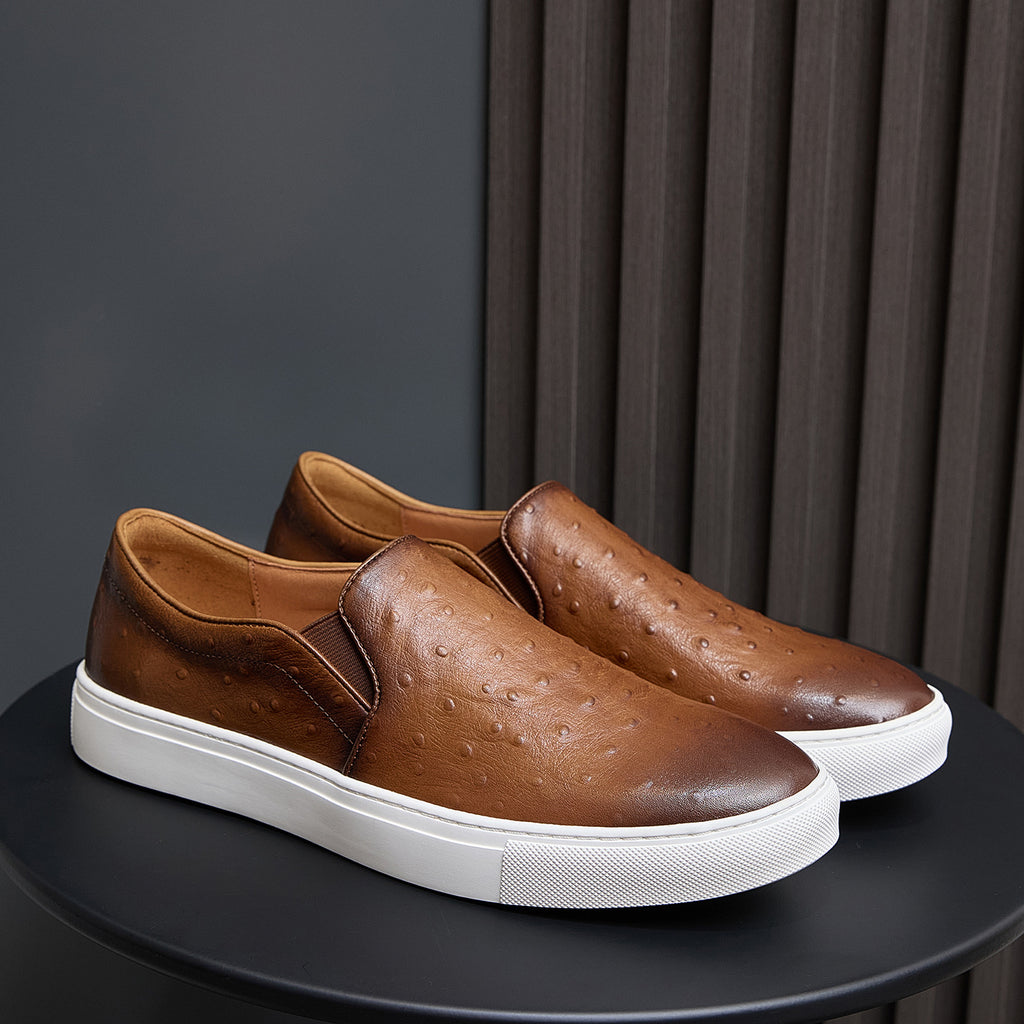 Men's brown slip-on leather sneakers with white rubber sole and embossed texture