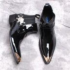 Black patent Chelsea dress boots, slip-on design with decorative silver buckle and straps.